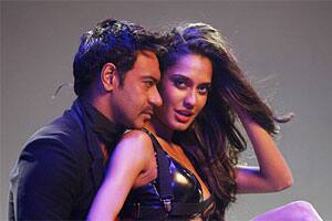 Ajay Devgn with a hot item in 'Rascals'.