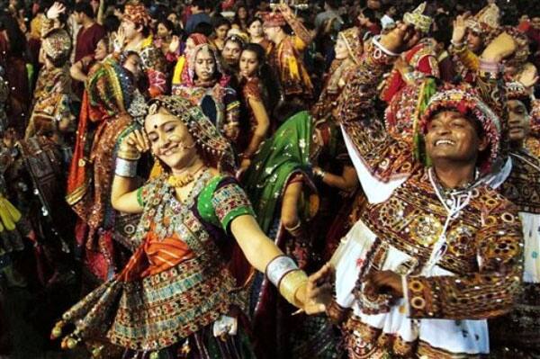 Indians in traditional attire take part in Garba, a traditional dance of western Indian state of Gujarat on the first night of nine nights festival 