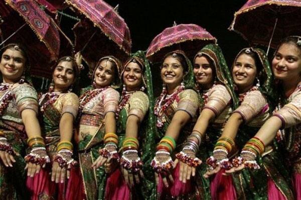 Indian women in traditional attire take part in Garba, a traditional dance of western Indian state of Gujarat, on the second night of the nine-night festival 