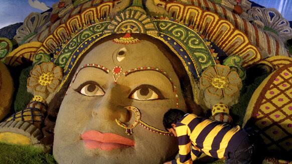 Sand artist Sudarshan Pattnaik creates a sculpture of Hindu Goddess Durga ahead of Durga Puja festival in Siliguri.