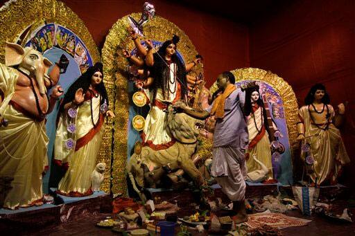 A Hindu priest worships goddess Durga on the first day of the Durga Puja festival in Kolkata.