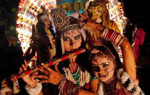 Young Indian artists dressed as Hindu deities Radha, right and Krishna, left, participate in a Dussehra procession in Allahabad.