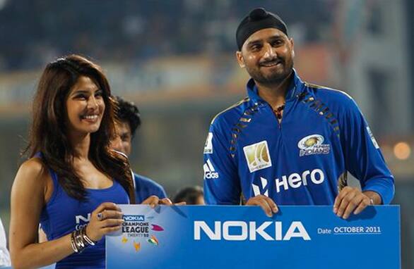 Mumbai Indians' captain Harbhajan Singh receives Man of the Match award from Priyanka Chopra after his team's win over Royal Challengers Bangalore in the Champions League Twenty20 cricket final match in Chennai.