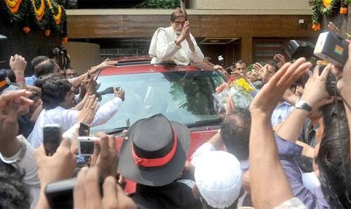 Amitabh Bachchan greets fans waiting to wish him on his birthday outside his home Jalsa. 