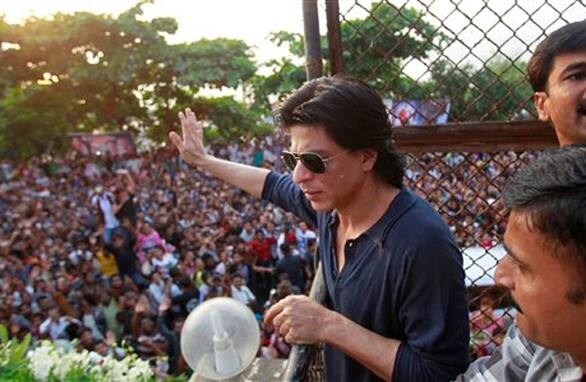 Shahrukh Khan waves to his fan from his house on his birthday in Mumbai.