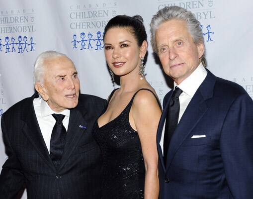 Honoree actor Kirk Douglas, left, poses with his son actor Michael Douglas and actress Catherine Zeta-Jones at the 