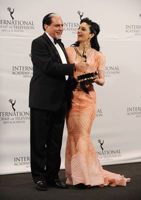 Zee Entertainment Chairman Subhash Chandra (L) and British actress Archie Panjabi pose at Nespresso Press Room at the 39th International Emmy Awards at the Hilton New York.