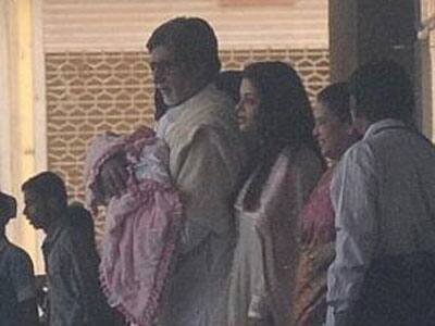 Amitabh Bachchan has his grand-daughter in his arms as Aishwarya and her mother leave the hospital.