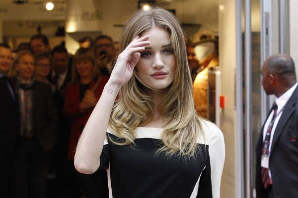 Rosie Huntington-Whiteley poses outside Marks & Spencer's Paris store during its inauguration.