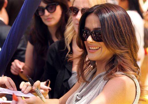 Film star Salma Hayek signs her autographs for fans as she arrives for the Australian premiere of the new animation feature 