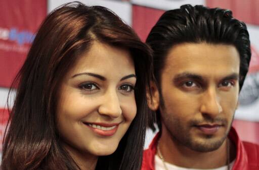 Bollywood actors Anushka Sharma, left, and Ranveer Singh smile during a press conference to promote their upcoming movie 