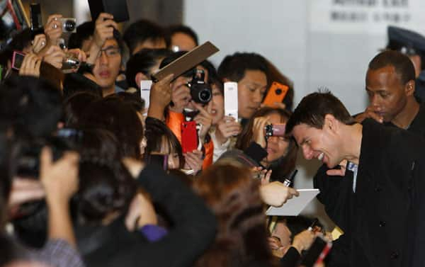 Hollywood star Tom Cruise greets fans upon his arrival at Haneda Airport in Tokyo.