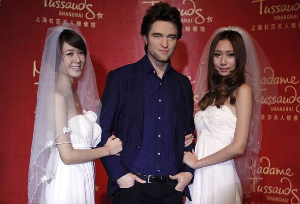 The waxwork of British actor Robert Pattinson is surrounded by 'brides' fans at Madame Tussauds in Shanghai, China.