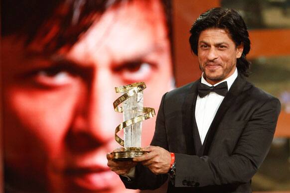 Shah Rukh Khan poses with his trophy after receiving award for his lifetime career during the 11th Marrakech International Film Festival in Marrakech, Morocco. 