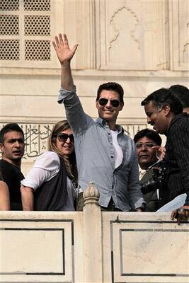 Hollywood star Tom Cruise waves to the crowd as he takes a tour of the landmark Taj Mahal in Agra.