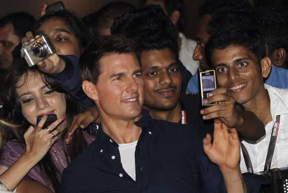 US actor Tom Cruise, center, poses with Indian fans as he arrives for a special screening of his film Mission Impossible Ghost Protocol in Mumbai.