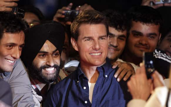 US actor Tom Cruise, center, poses with Indian fans as he arrives for a special screening of his film Mission Impossible Ghost Protocol in Mumbai.