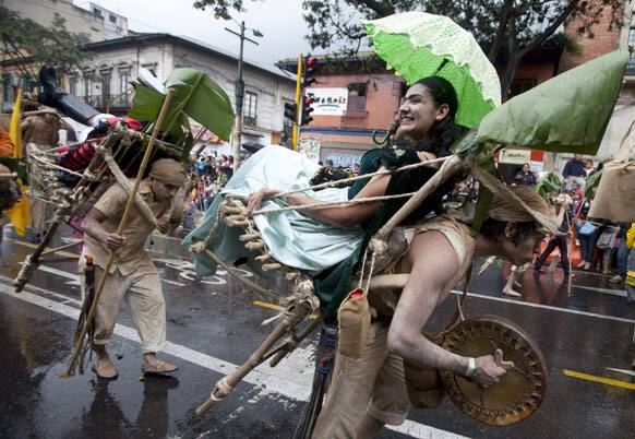 Members of the theater group Paisaje Cultural Cafetero march in the inaugural parade marking the 13th annual IberoAmerican Festival of Theater (FITB) in Bogota.