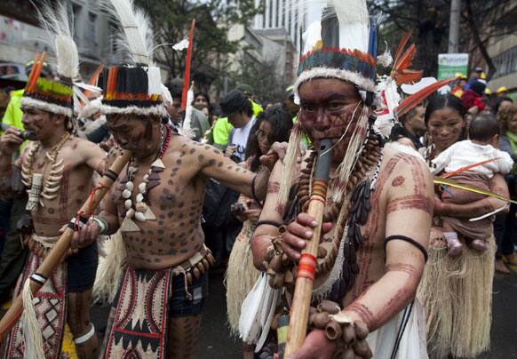 An indigenous group perform in the inaugural parade marking the 13th annual IberoAmerican Festival of Theater (FITB) in Bogota.