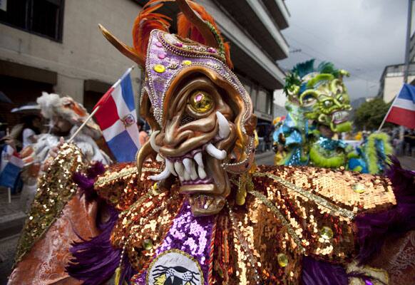 Masked dancers perform in the inaugural parade marking the 13th annual IberoAmerican Festival of Theater (FITB) in Bogota.