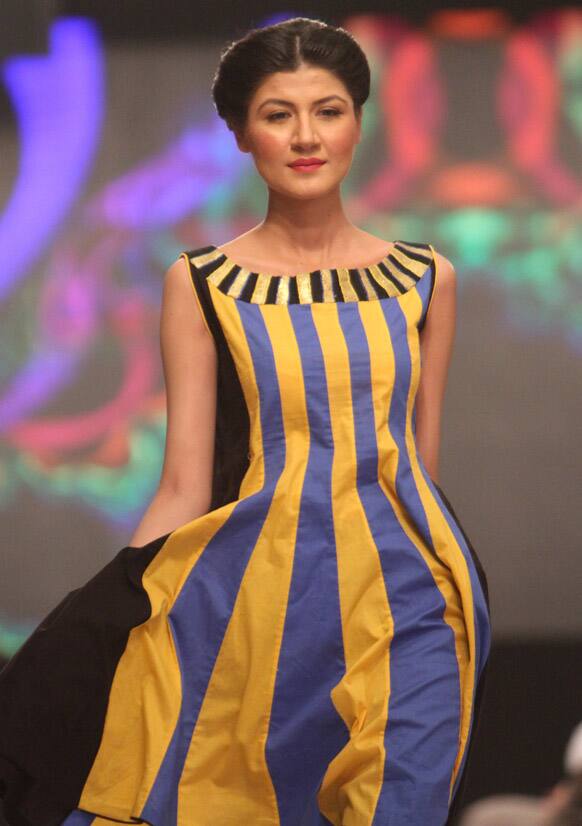 A Pakistani model walks on the ramp to display new trends during a fashion show in Karachi.