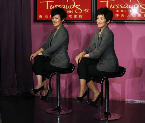 Award winning Hong Kong actress Sandra Ng, left, poses with her wax figure during its unveiling ceremony at Madame Tussauds in Hong Kong.