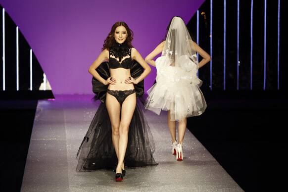 Models present creations from EVE'S Temptation Lingerie Collection 2012 during China Fashion Week in Beijing.