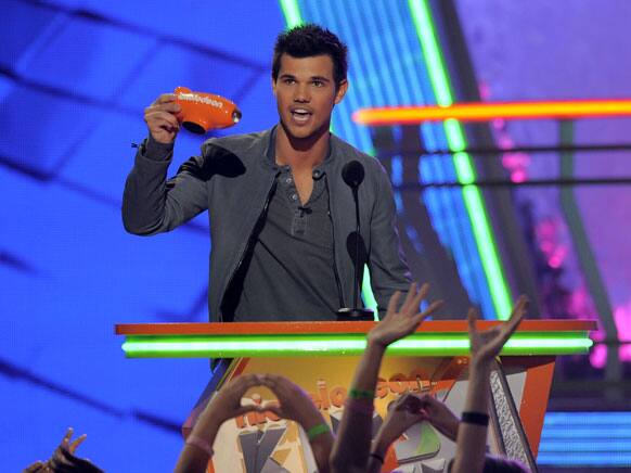 Taylor Lautner accepts the award for favorite buttkicker onstage at Nickelodeon's 25th Annual Kids' Choice Awards.