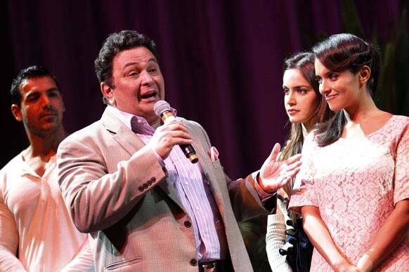 Bollywood actor Rishi Kapoor, second left, speaks while fellow actors, John Abraham, left, Shazahn Padamsee, second right, and Asin Thottumkal, look on during a press conference for Bollywood's new film Housefull 2.