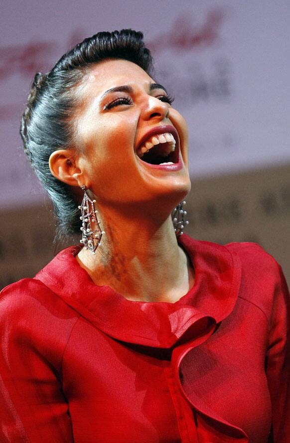 Bollywood actress Jacqueline Fernandez breaks into laughter during a press conference for Bollywood's new film Housefull 2 which makes its world premiere in Singapore.