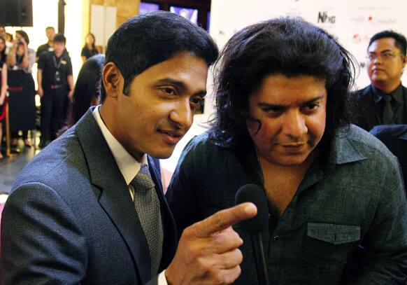 Bollywood actor Shreyas Talpade, left, and director Sajid Khan, arrive for Bollywood's film Housefull 2 world premiere in Singapore.