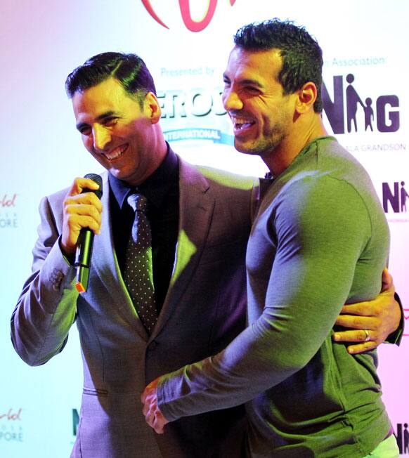 Bollywood actors Akshay Kumar, left and John Abraham, arrive for Bollywood's film Housefull 2 world premiere in Singapore.