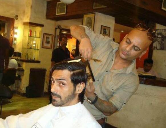 Arjun Rampal in the middle of a haircut, for his upcoming movie 'Chakravyuha'.