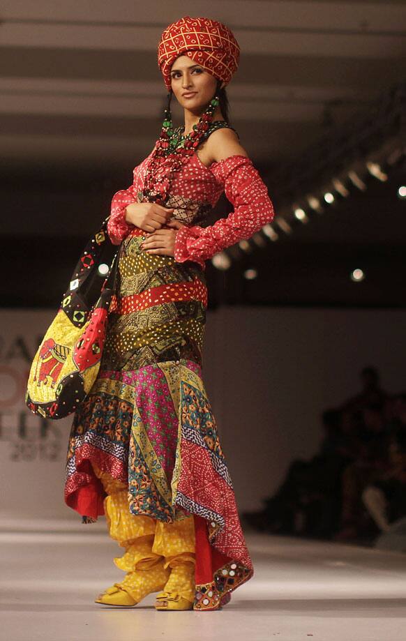 A Pakistani model presents a creation of Gift University designers during Islamabad Fashion Week.