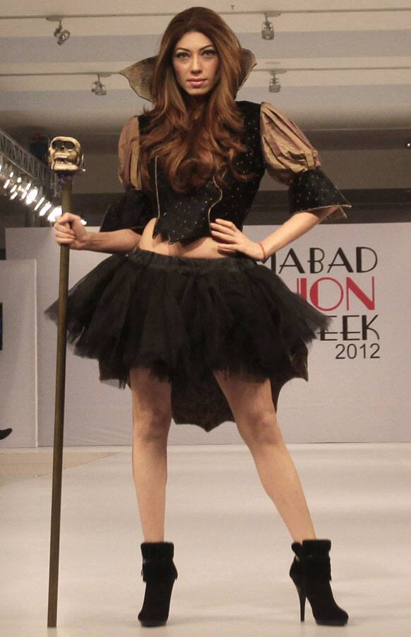 A model presents a creation of Iqra University designers during Islamabad Fashion Week.