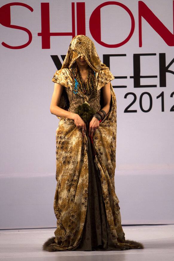 A model presents a creation of Gift University designers during a Fashion Week, in Islamabad.