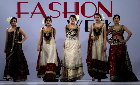 Models present creations of a Pakistani designer Shaianne Malik during a Fashion Week, in Islamabad.