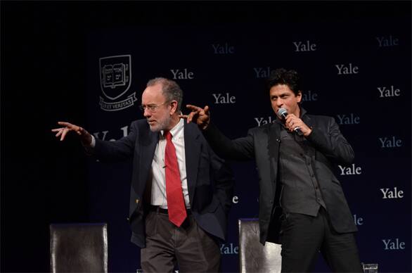 Shah Rukh Khan teaches Yale Master Jeffrey Brenzel some of his signature steps.