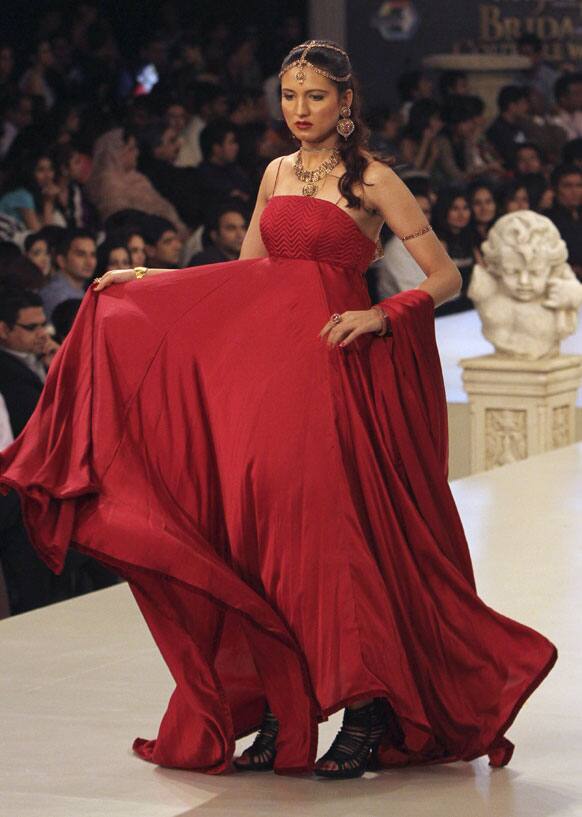 A Pakistani model presents a creation by designer Nadia Chhotani, during Bridal Couture Week in Karachi.