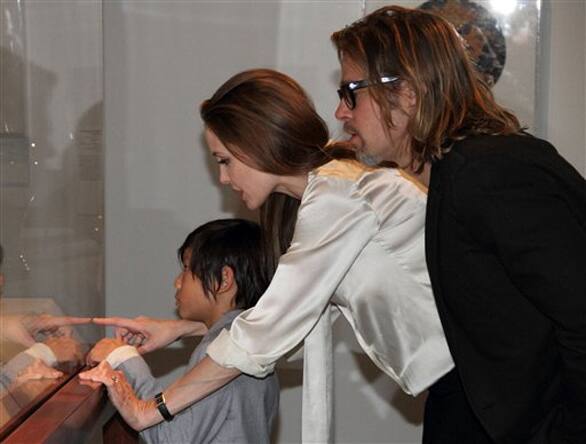 Angelina Jolie, center, sports an engagement ring as she and Brad Pitt, and their son, Pax view works from the Chinese collection at the The Los Angeles County Museum of Art, in Los Angeles.