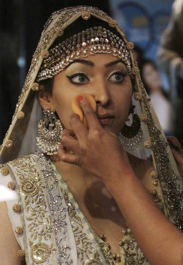 A Pakistani model has make up applied, during Bridal Couture Week in Karachi, Pakistan.