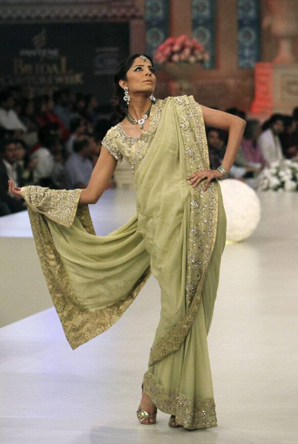 A Pakistani model presents a creation by Pakistani designer Cara, during Bridal Couture Week in Karachi, Pakistan.