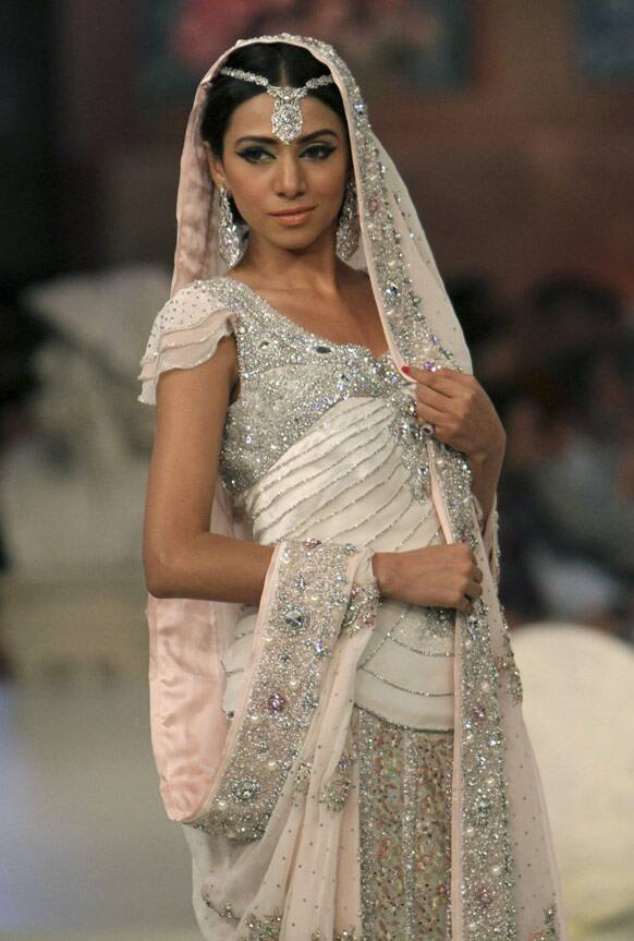 A Pakistani model presents a creation by Pakistani designer Cara, during Bridal Couture Week in Karachi, Pakistan.