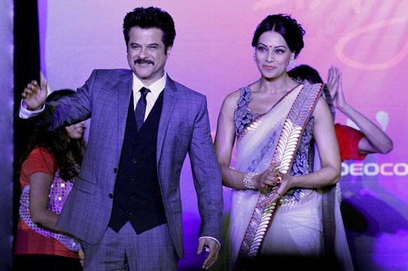 Anil Kapoor and Bipasha Basu, wave as they arrived at the International Indian Film Academy's (IIFA) Weekend and Awards media conference, in Singapore.