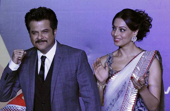 Anil Kapoor and Bipasha Basu, dance as they arrived at the International Indian Film Academy's (IIFA) Weekend and Awards media conference, in Singapore.