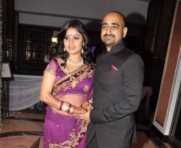 Newly weds Sunidhi Chauhan and Hitesh Sonik pose for the shutterbugs at their wedding reception.