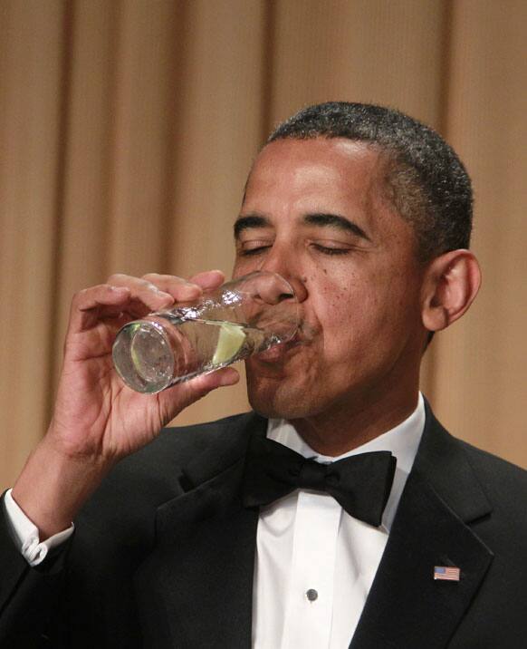 President Barack Obama drinks his beverage after being offered a toast at the White House Correspondents' Association Dinner.