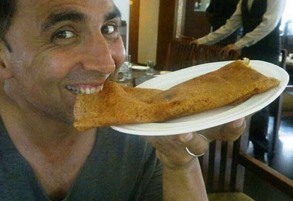 Akshay Kumar takes a bite off a South Indian delicacy, dosa.