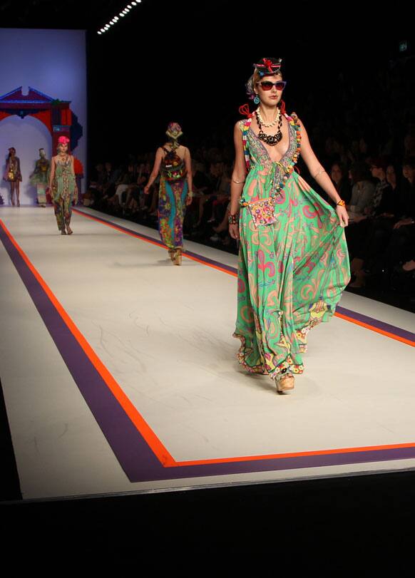 Models wear outfits from designer Camilla on the runway during Fashion Week Australia in Sydney.