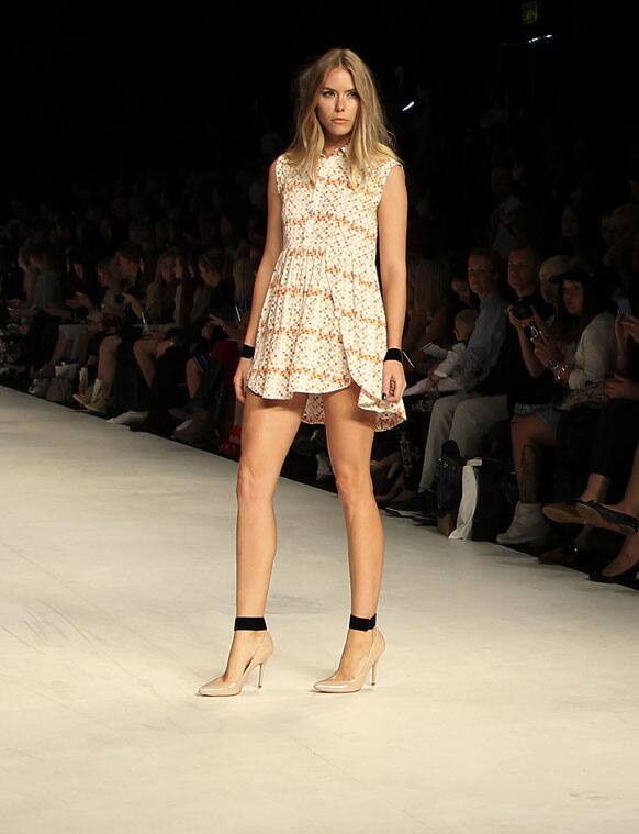 A model wearing an outfit from designer Toi Et Moi Sydney poses at the end of the runway during Fashion Week Australia in Sydney.